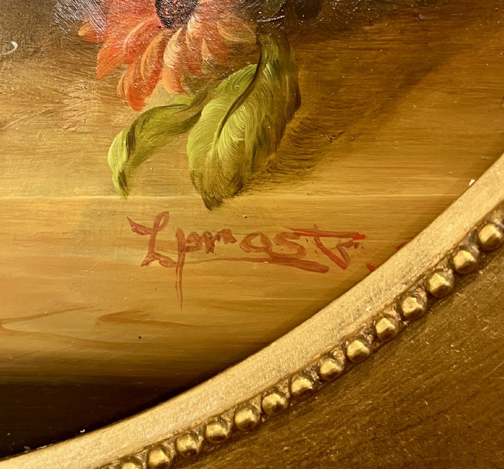 A pair of oil paintings on board featuring floral bouquets framed within oval apertures inside ornate gold frames. View VI