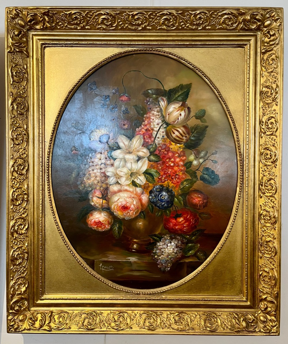 A pair of oil paintings on board featuring floral bouquets framed within oval apertures inside ornate gold frames. View VII