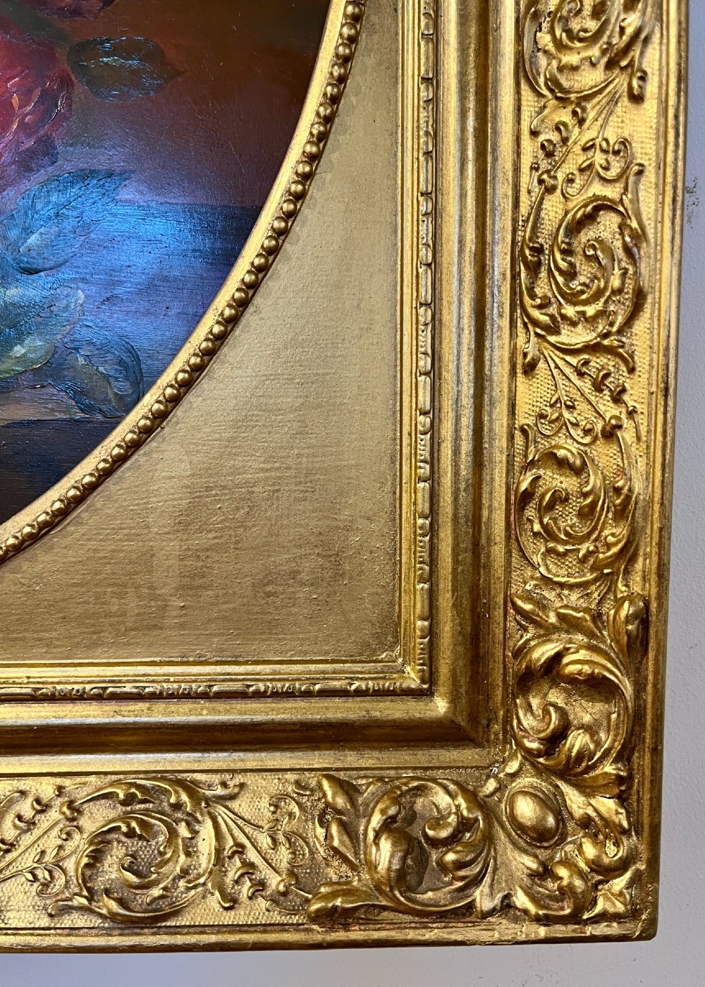 A pair of oil paintings on board featuring floral bouquets framed within oval apertures inside ornate gold frames. View XI