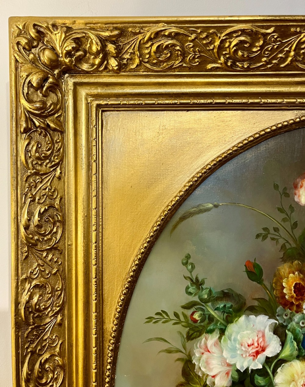 A pair of oil paintings on board featuring floral bouquets framed within oval apertures inside ornate gold frames. View XIII