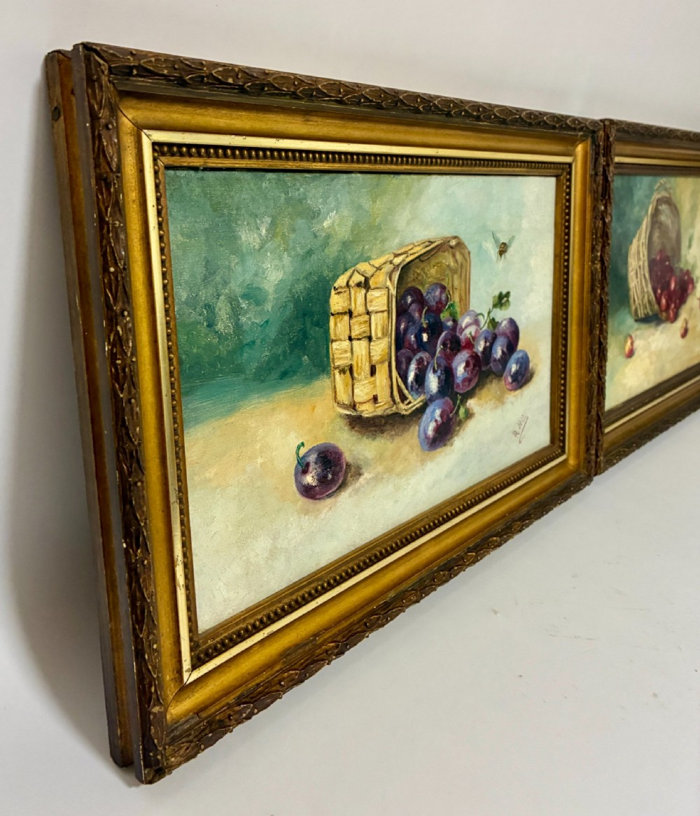 A pair of rectangular oil paintings depicting plums and cherries spilling from woven baskets in gilt wood frames. View VII