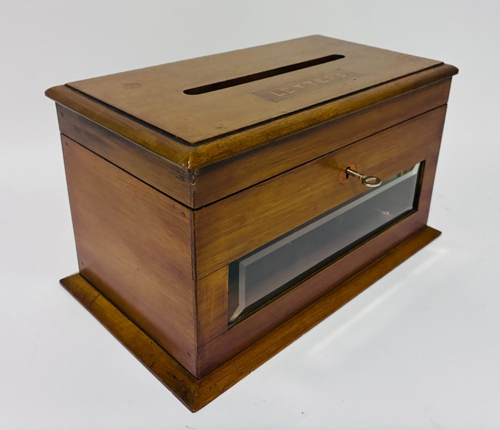 An antique mahogany tabletop letter box featuring a top posting slot, carved LETTERS plaque, key lock mechanism, and bevelled glass front panel. View X