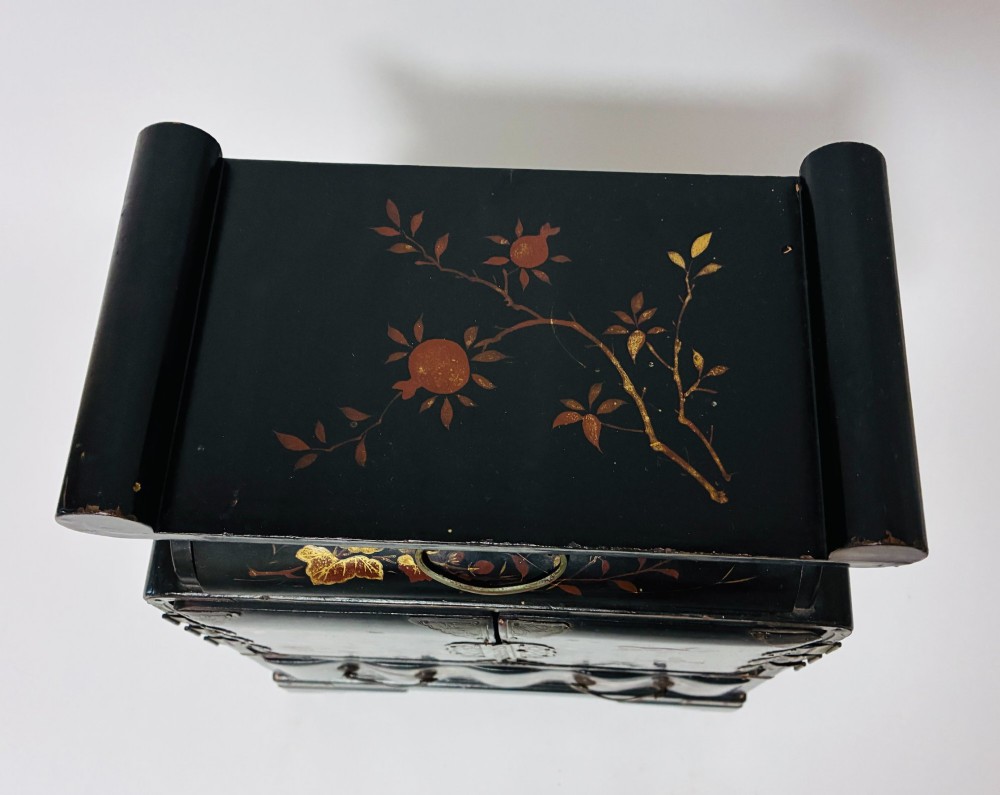 A black lacquered Japanese tabletop cabinet featuring hand-painted botanical motifs and decorative engraved brass corner mounts. View III