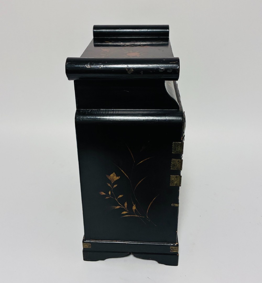 A black lacquered Japanese tabletop cabinet featuring hand-painted botanical motifs and decorative engraved brass corner mounts. View XII