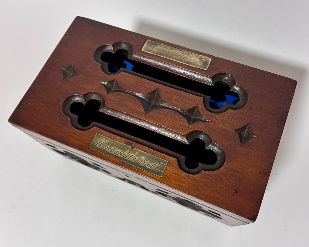 A rectangular dark wood correspondence box with Gothic Revival carved quatrefoil cut-outs backed in blue fabric and brass plates on top marked Answered and Unanswered. View II