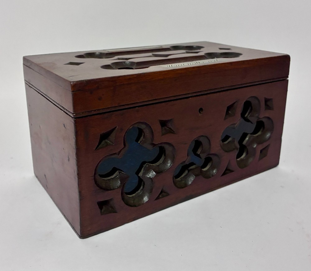 A rectangular dark wood correspondence box with Gothic Revival carved quatrefoil cut-outs backed in blue fabric and brass plates on top marked Answered and Unanswered. View VII