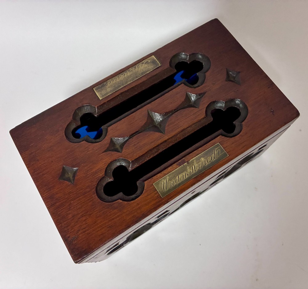 A rectangular dark wood correspondence box with Gothic Revival carved quatrefoil cut-outs backed in blue fabric and brass plates on top marked Answered and Unanswered. View VIII