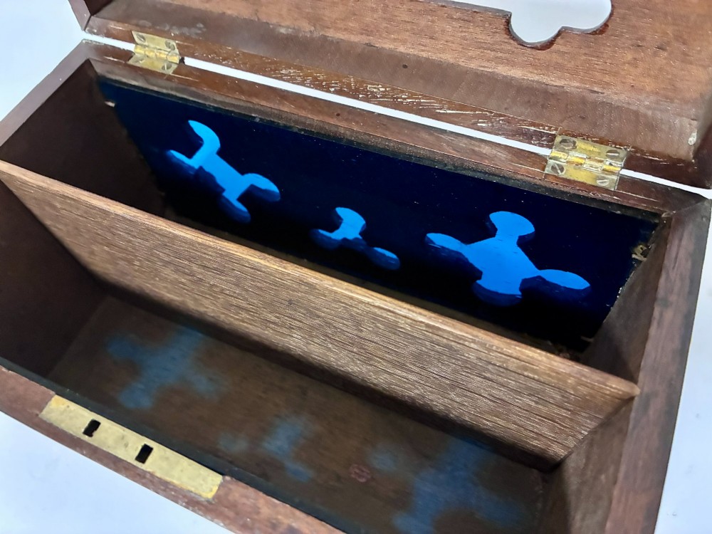 A rectangular dark wood correspondence box with Gothic Revival carved quatrefoil cut-outs backed in blue fabric and brass plates on top marked Answered and Unanswered. View X