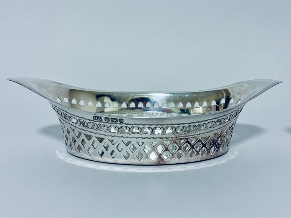 A pair of oval Victorian silver bonbon dishes featuring lattice-pierced reticulated sides and flared handles. View III