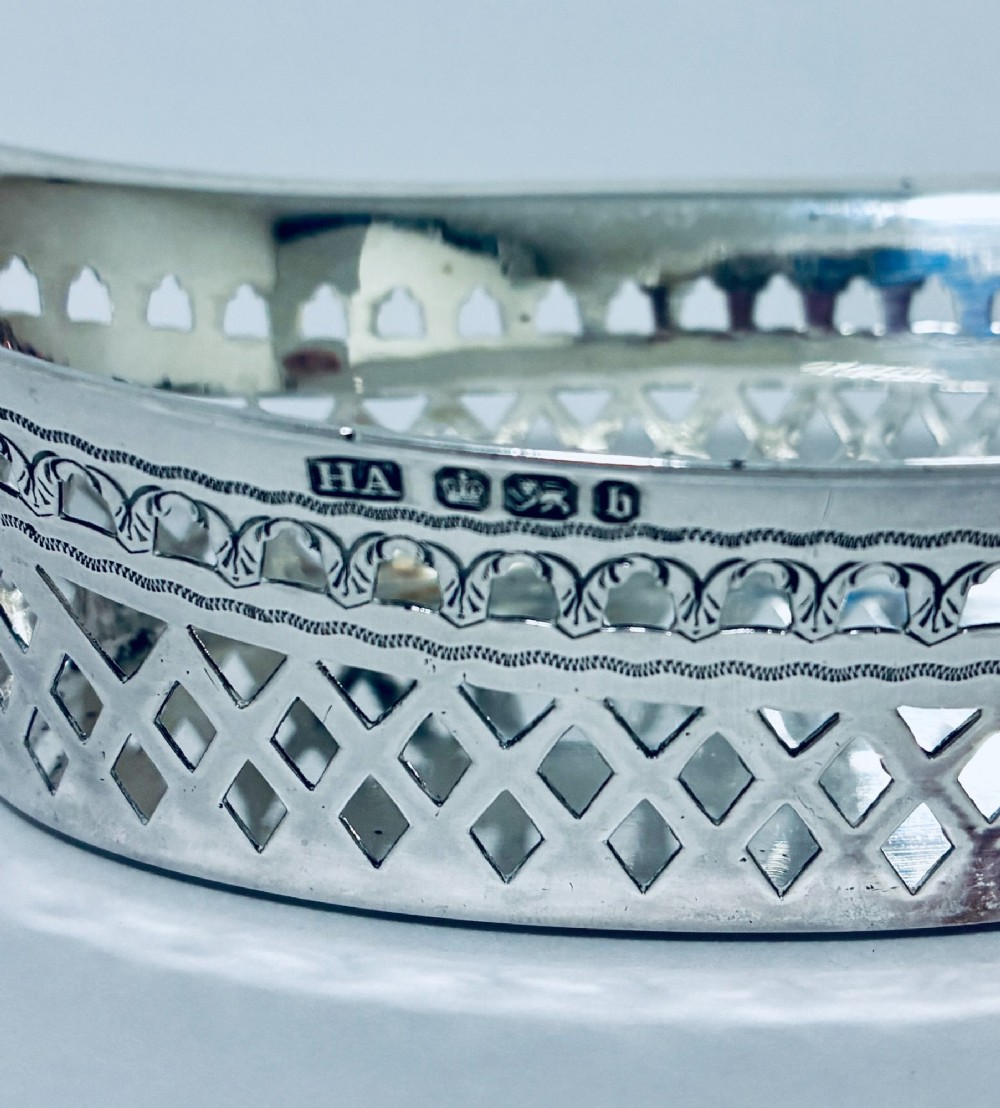 A pair of oval Victorian silver bonbon dishes featuring lattice-pierced reticulated sides and flared handles. View IV