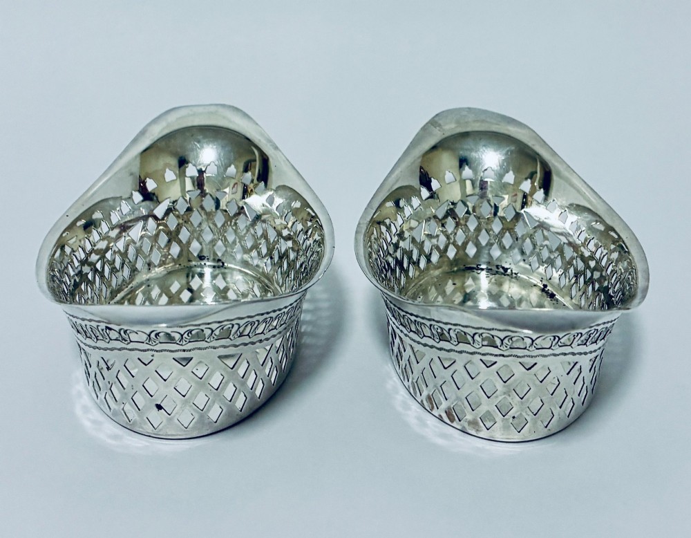 A pair of oval Victorian silver bonbon dishes featuring lattice-pierced reticulated sides and flared handles. View VI