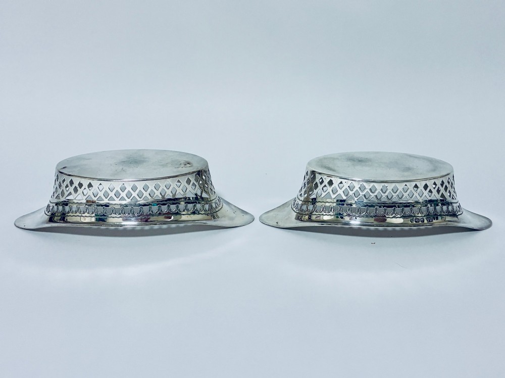 A pair of oval Victorian silver bonbon dishes featuring lattice-pierced reticulated sides and flared handles. View IX