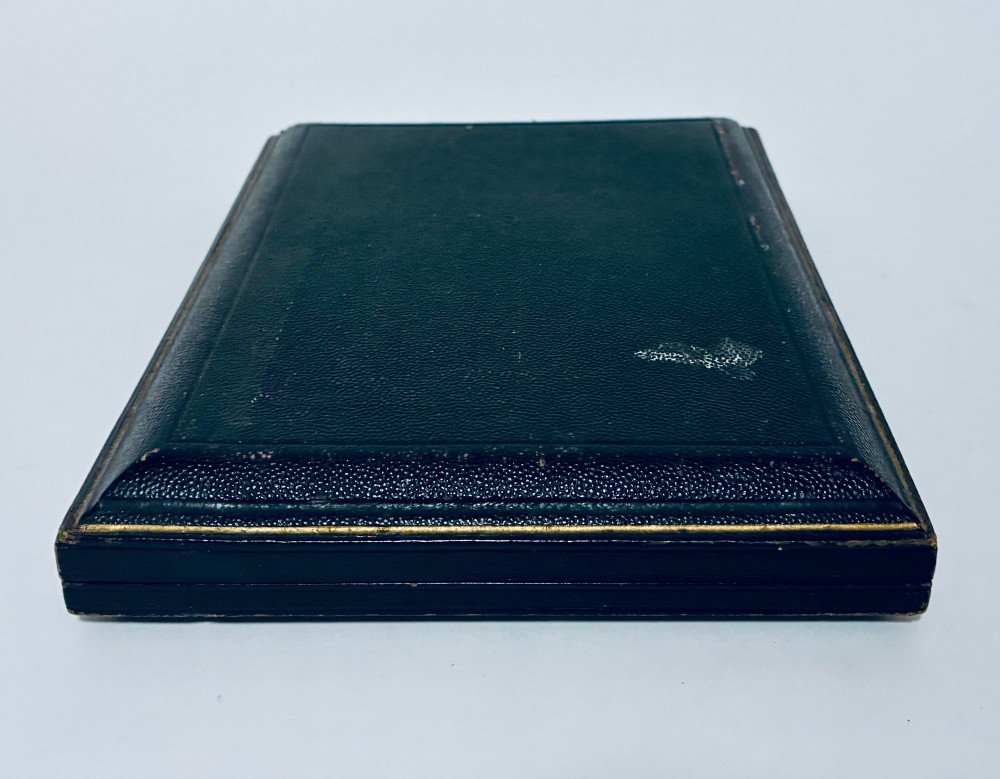 An open dark fitted presentation case lined with white satin and blue velvet containing six silver apostle teaspoons with twisted stems and matching silver sugar tongs. View XIII