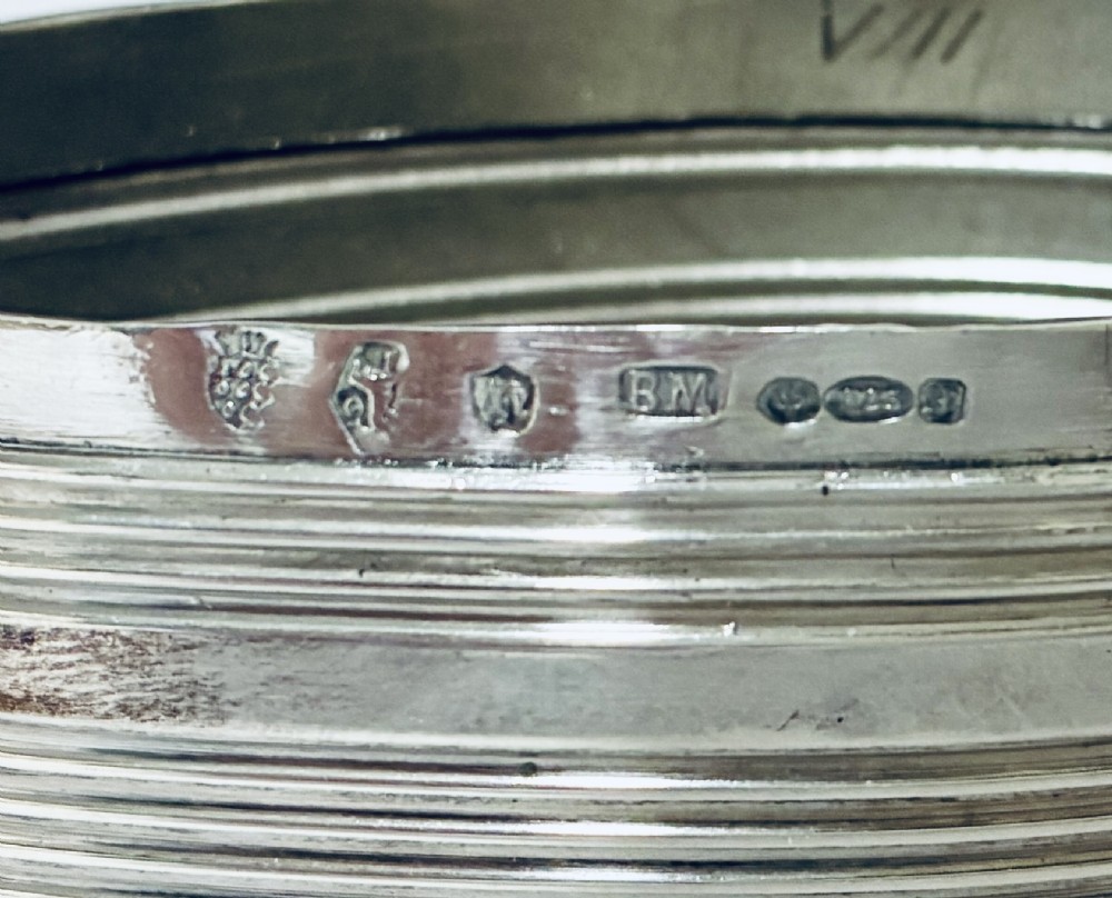 An oval silver snuff box featuring a relief equestrian scene on the hinged lid and reeded side walls with carved scroll borders. View IV