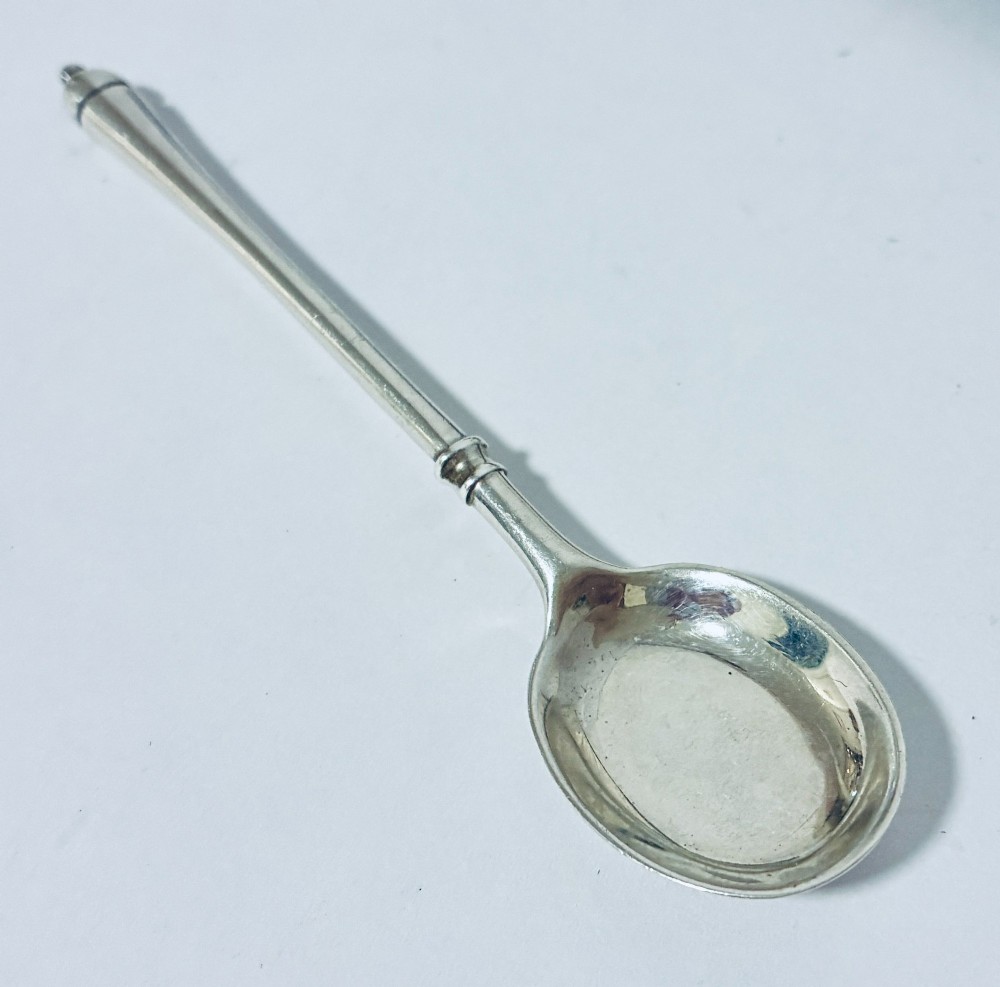 A set of six silver coffee spoons with turned handles stored inside a black fitted presentation case lined with velvet and cream satin. View V