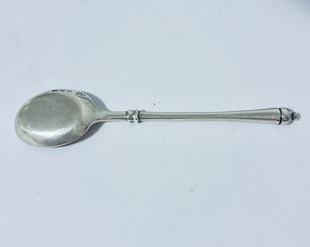 A set of six silver coffee spoons with turned handles stored inside a black fitted presentation case lined with velvet and cream satin. View VI