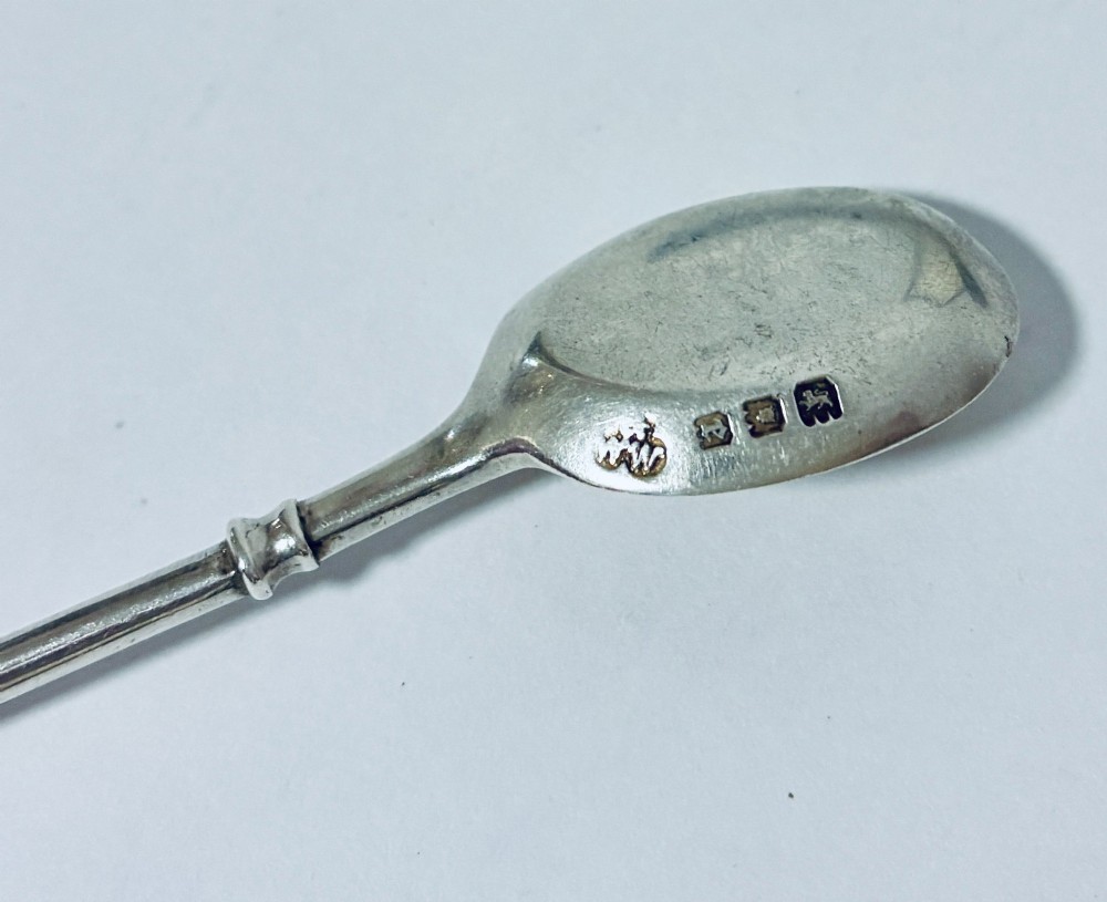 A set of six silver coffee spoons with turned handles stored inside a black fitted presentation case lined with velvet and cream satin. View VII