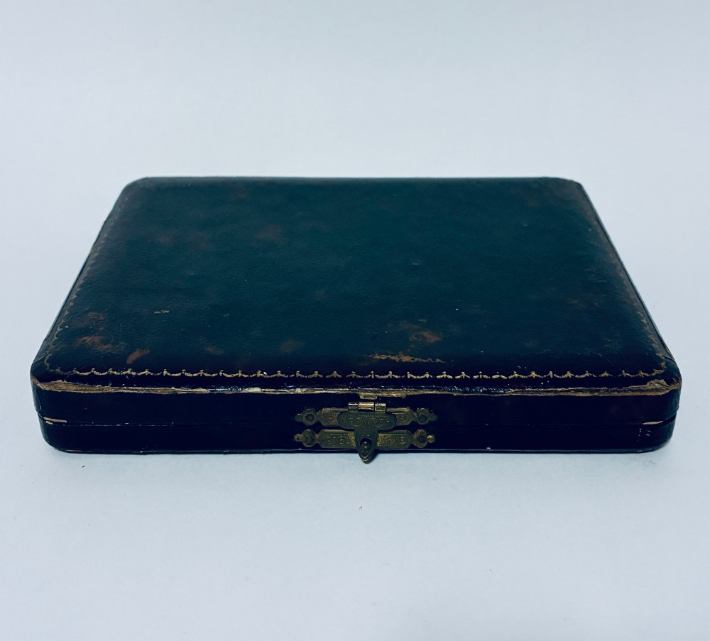 A set of six silver coffee spoons with turned handles stored inside a black fitted presentation case lined with velvet and cream satin. View VIII