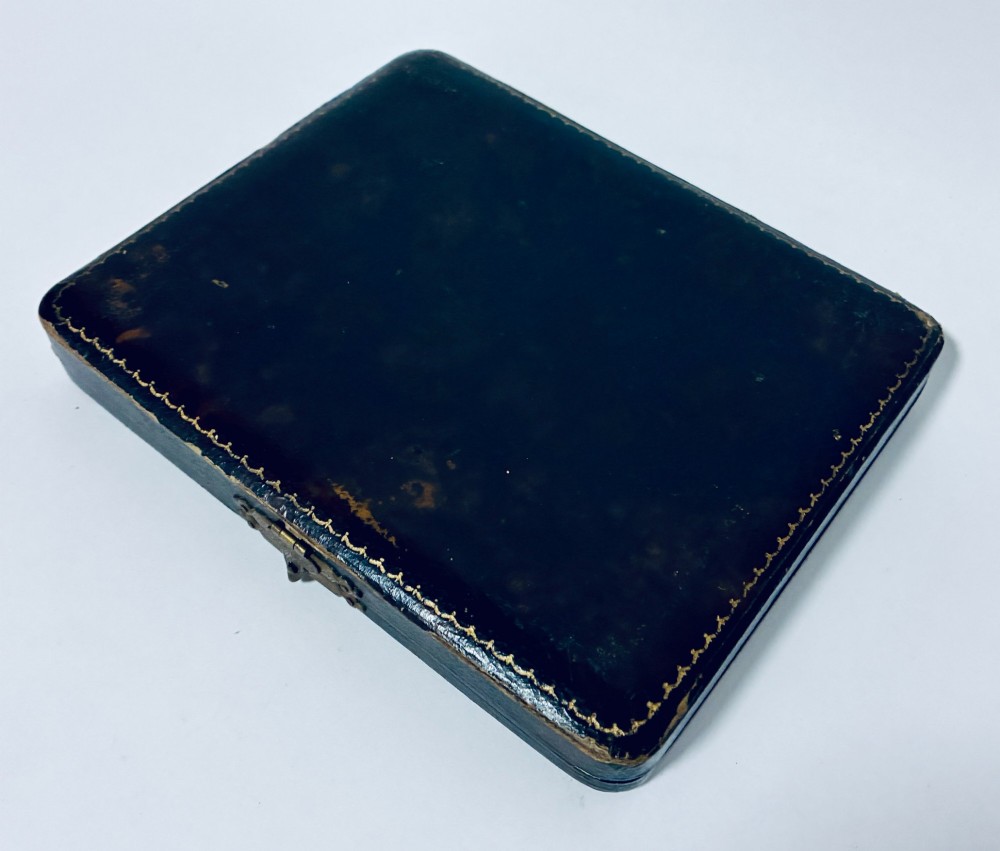 A set of six silver coffee spoons with turned handles stored inside a black fitted presentation case lined with velvet and cream satin. View IX