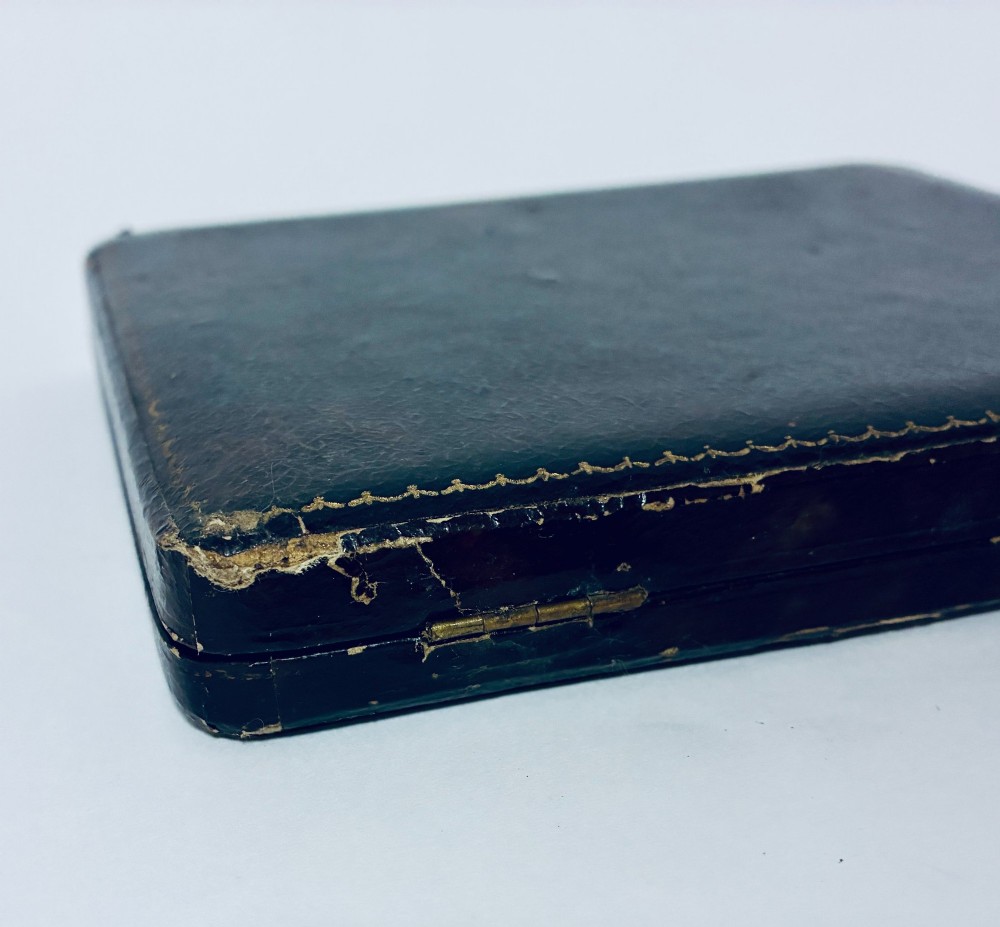 A set of six silver coffee spoons with turned handles stored inside a black fitted presentation case lined with velvet and cream satin. View XII