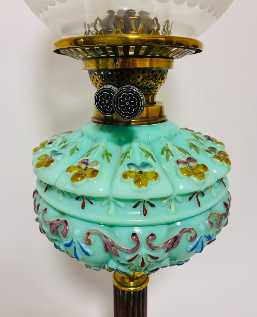 A Victorian oil lamp featuring an etched frosted glass shade, a turquoise enamelled font, and a brass column on a dark stepped base. View V
