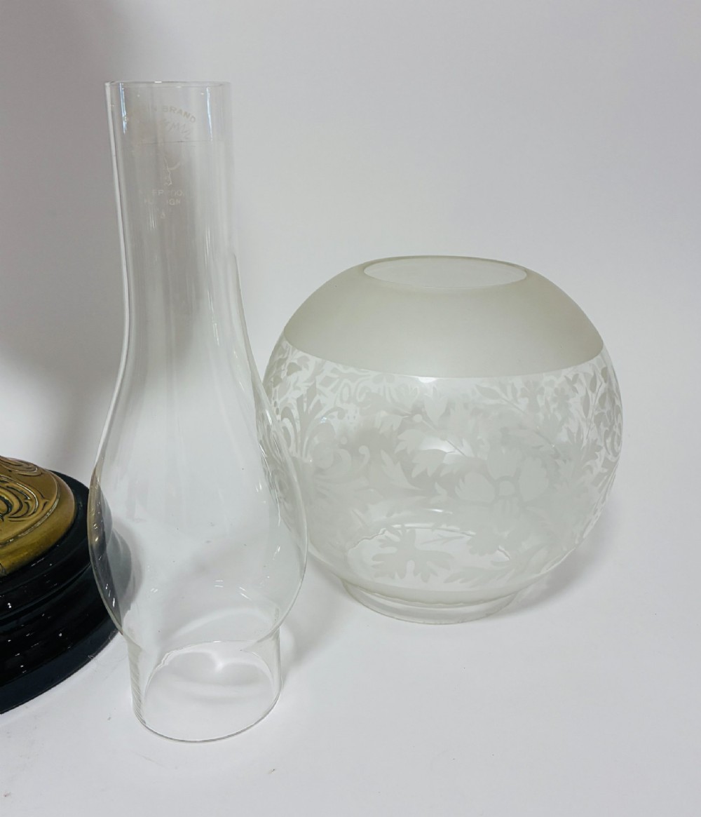 A Victorian oil lamp featuring an etched frosted glass shade, a turquoise enamelled font, and a brass column on a dark stepped base. View VII