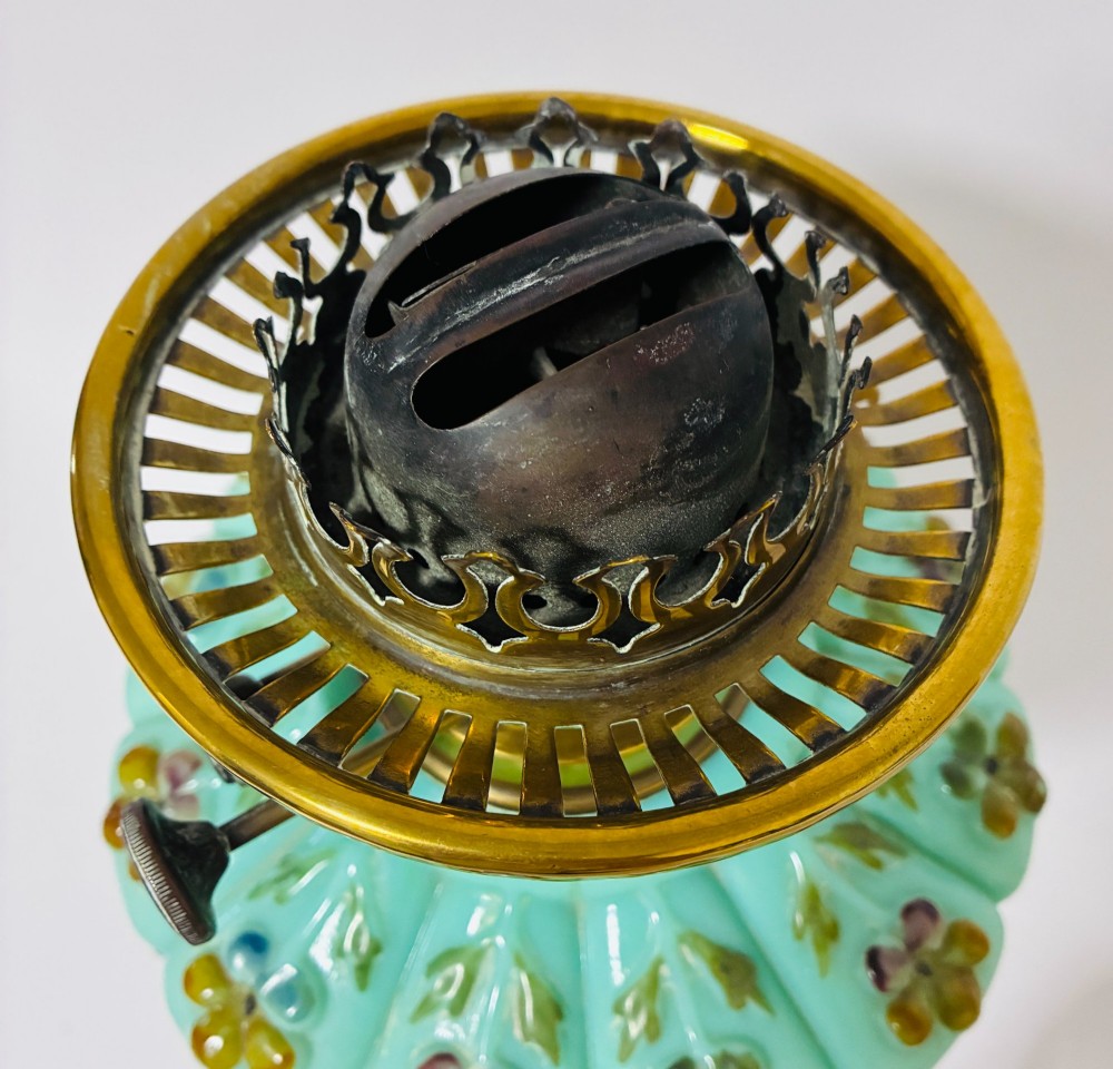A Victorian oil lamp featuring an etched frosted glass shade, a turquoise enamelled font, and a brass column on a dark stepped base. View VIII