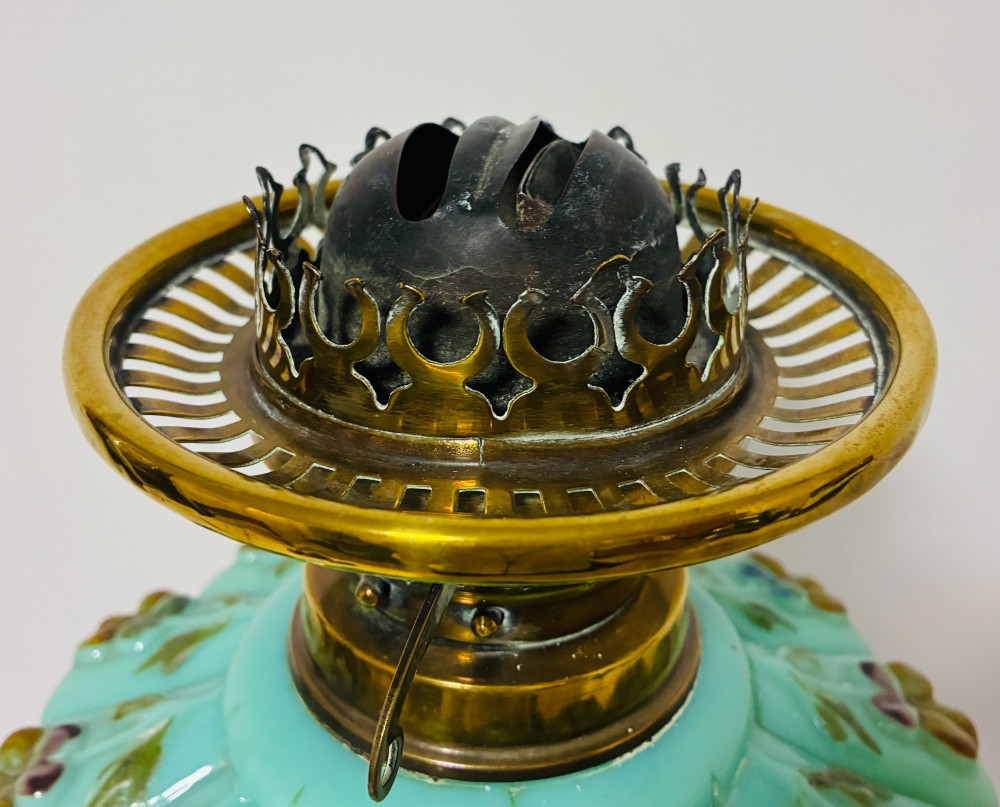 A Victorian oil lamp featuring an etched frosted glass shade, a turquoise enamelled font, and a brass column on a dark stepped base. View IX