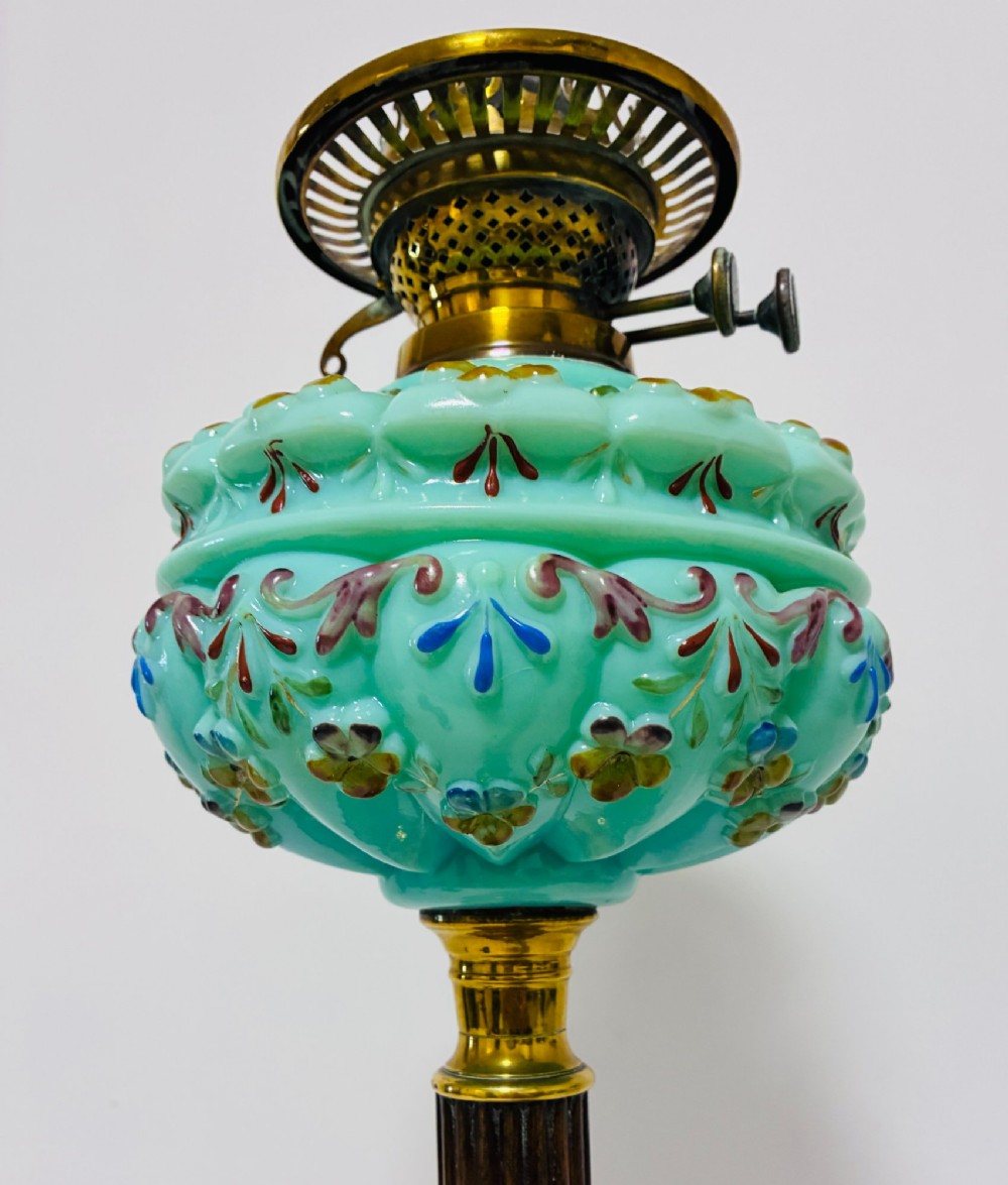 A Victorian oil lamp featuring an etched frosted glass shade, a turquoise enamelled font, and a brass column on a dark stepped base. View XI