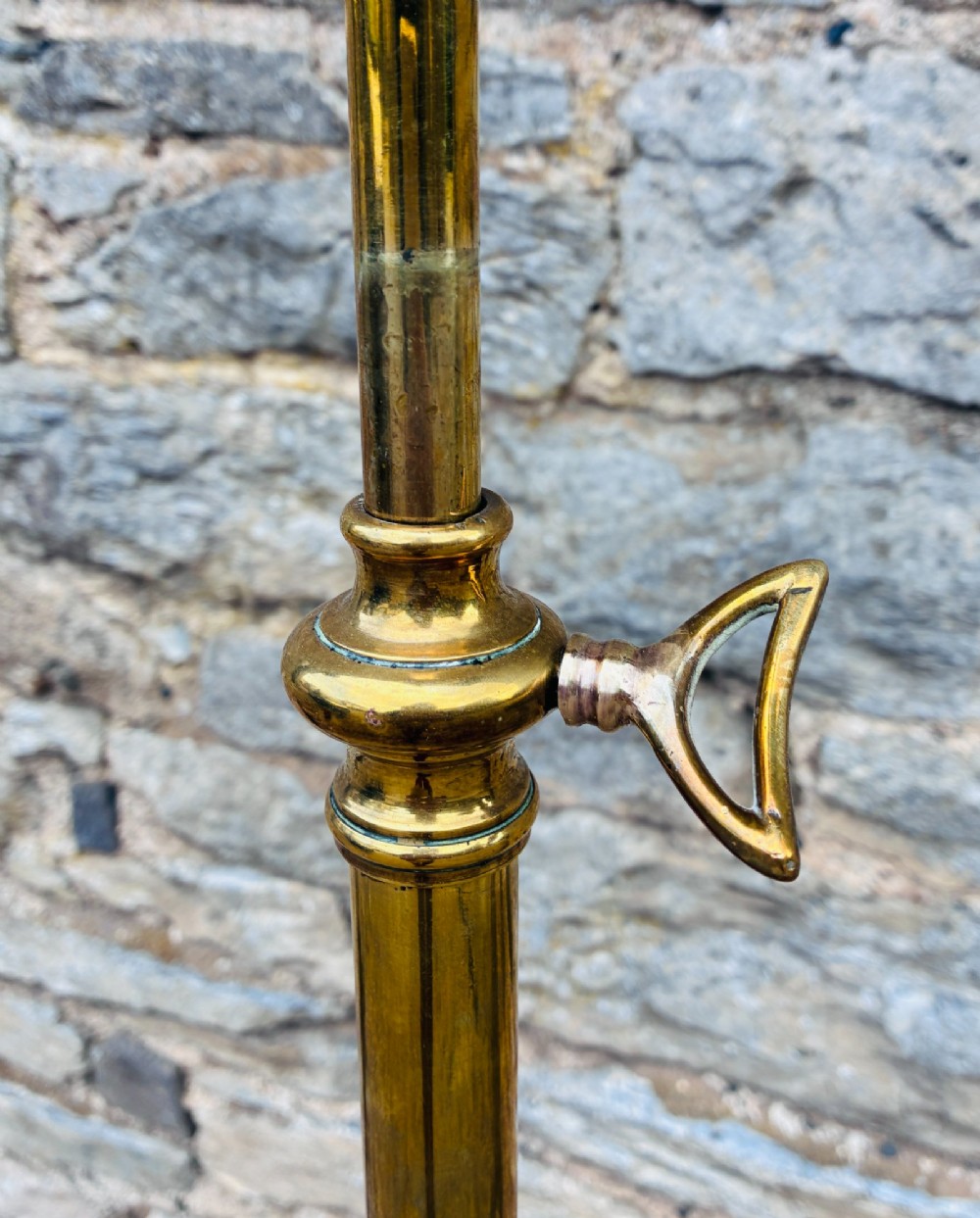 A Victorian brass telescopic floor lamp featuring a ornate tripod base, adjustable vertical stem, and converted oil font fitted with an electrical lamp holder. View V