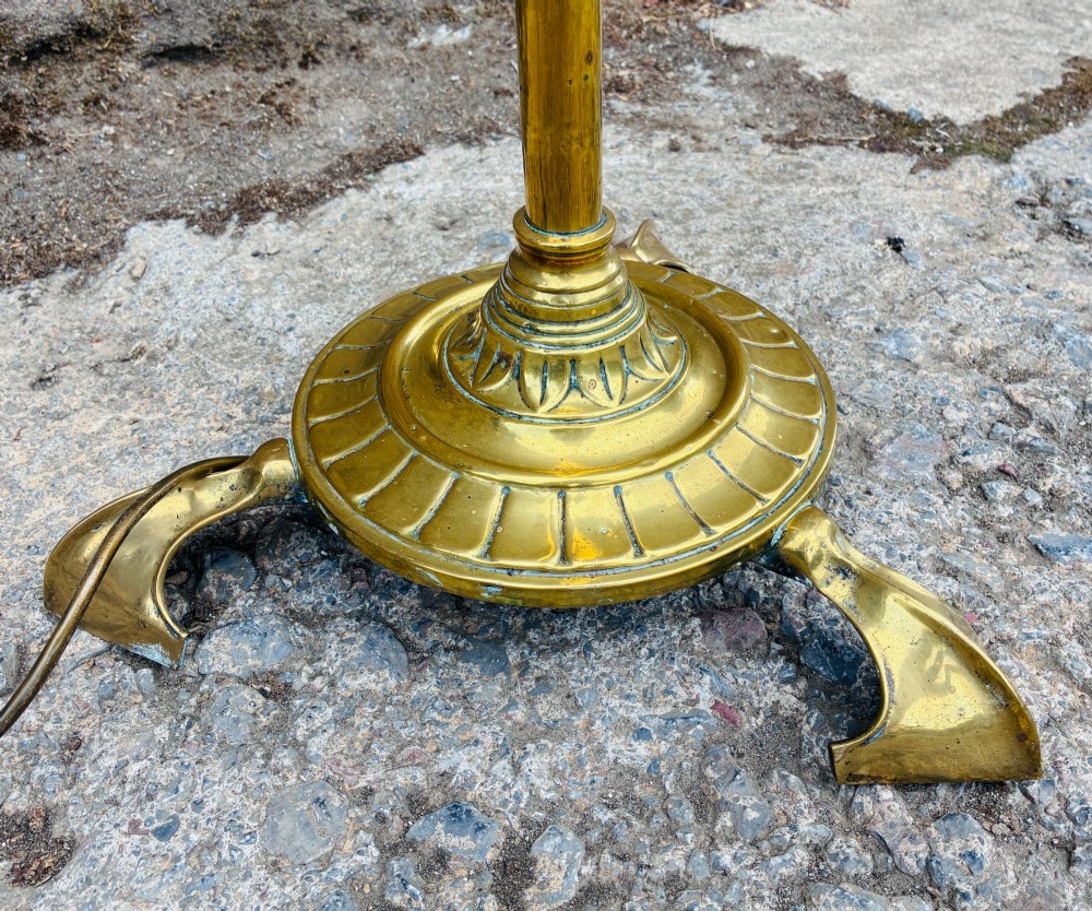 A Victorian brass telescopic floor lamp featuring a ornate tripod base, adjustable vertical stem, and converted oil font fitted with an electrical lamp holder. View VII