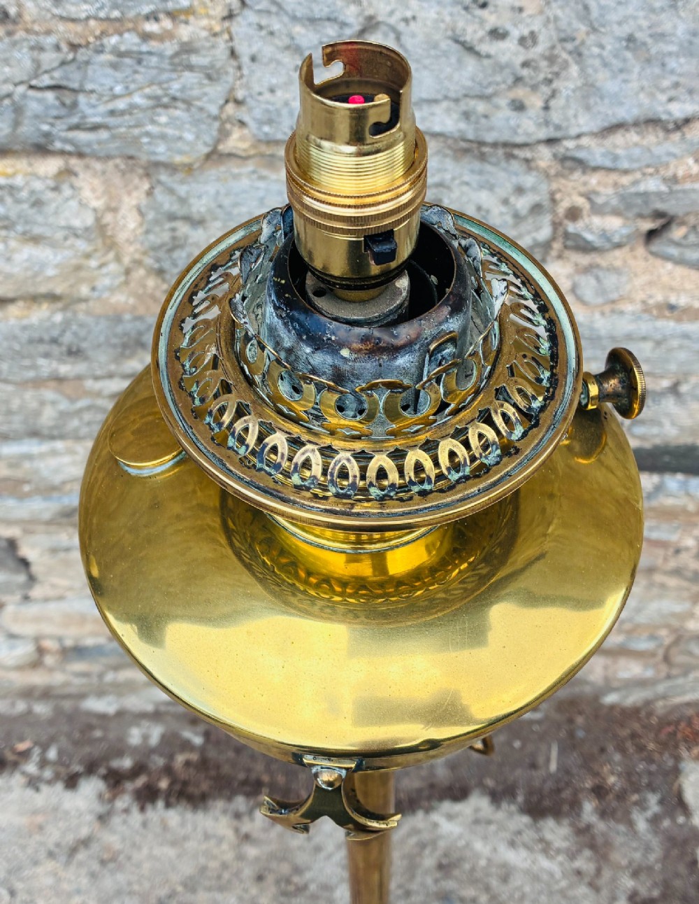 A Victorian brass telescopic floor lamp featuring a ornate tripod base, adjustable vertical stem, and converted oil font fitted with an electrical lamp holder. View IX