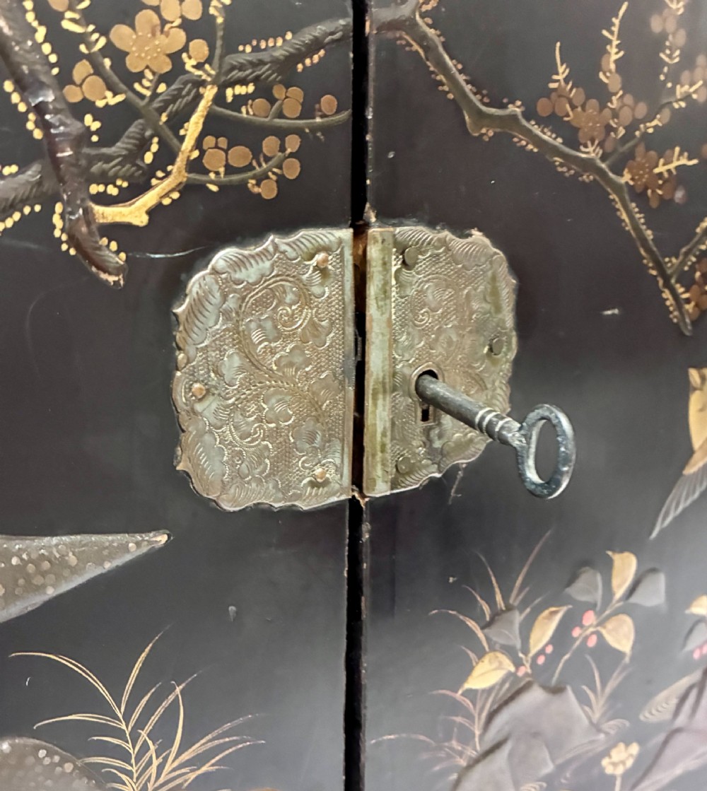 An antique Japanese black lacquer table cabinet decorated with gold bird and landscape scenes, fitted with metal corner brackets and a top handle. View III