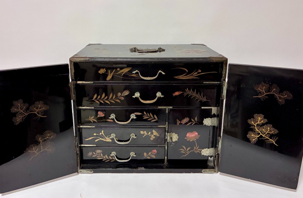 An antique Japanese black lacquer table cabinet decorated with gold bird and landscape scenes, fitted with metal corner brackets and a top handle. View IV