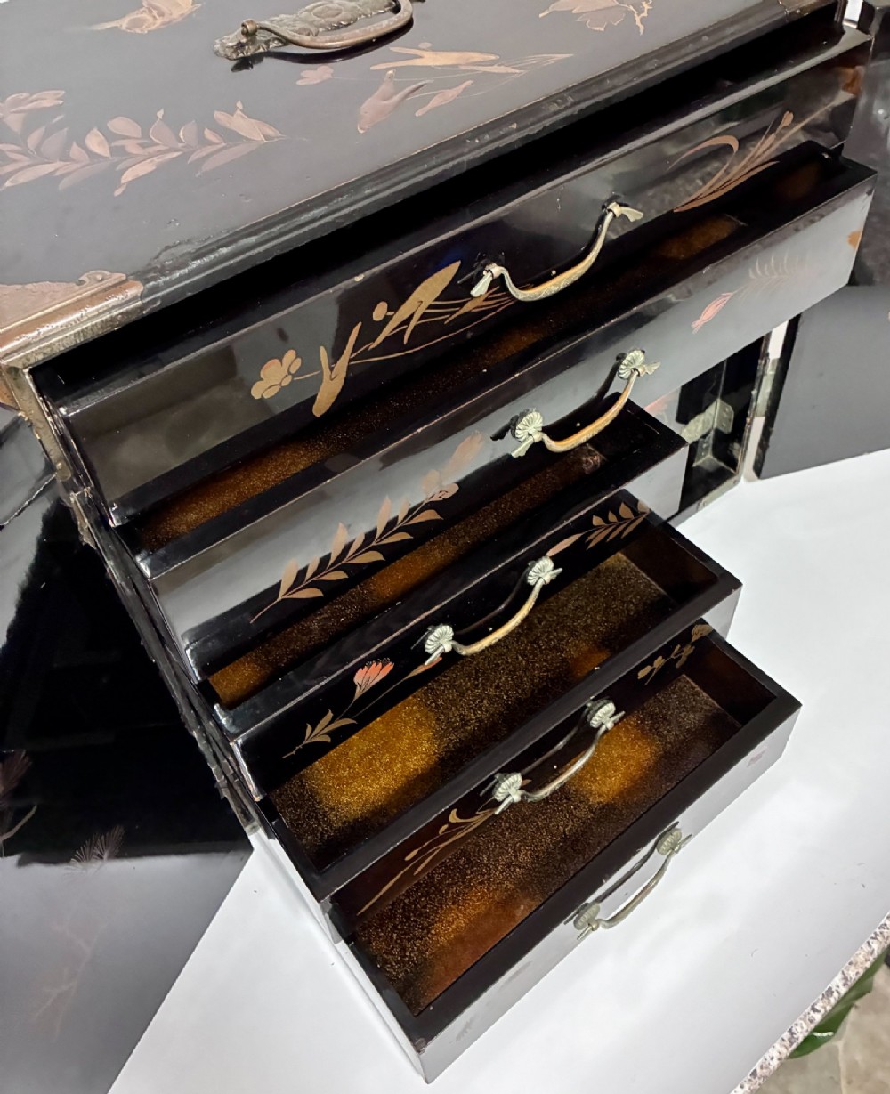 An antique Japanese black lacquer table cabinet decorated with gold bird and landscape scenes, fitted with metal corner brackets and a top handle. View VII