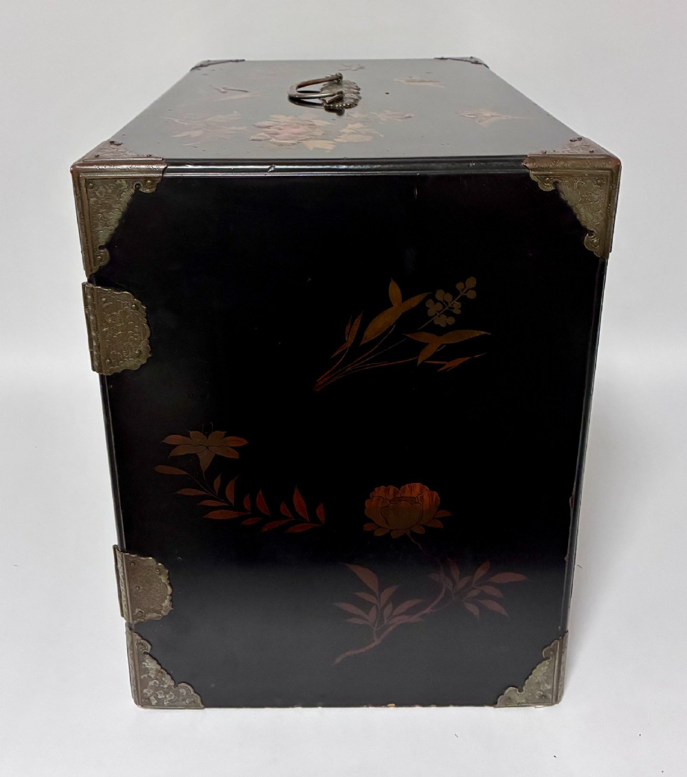An antique Japanese black lacquer table cabinet decorated with gold bird and landscape scenes, fitted with metal corner brackets and a top handle. View XI