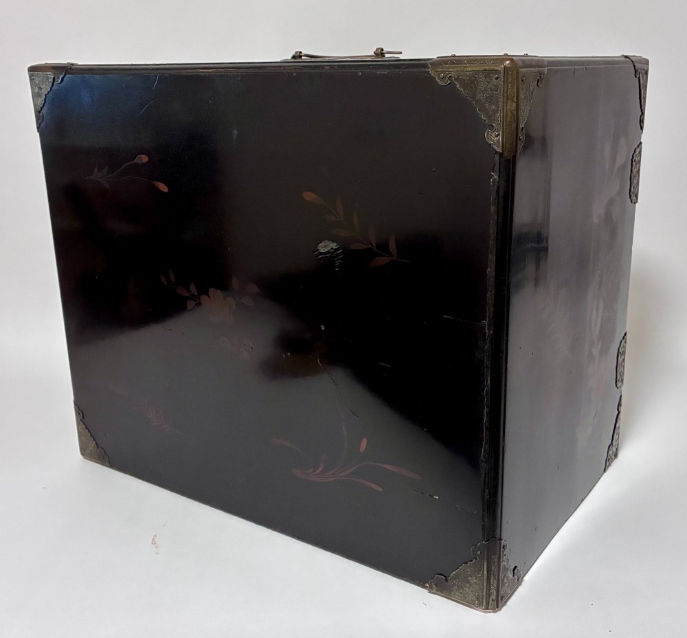An antique Japanese black lacquer table cabinet decorated with gold bird and landscape scenes, fitted with metal corner brackets and a top handle. View XIII
