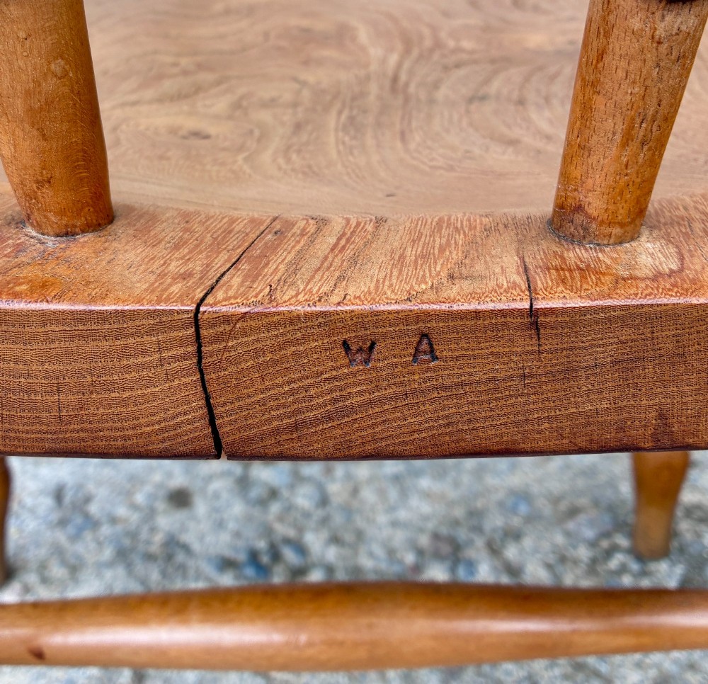 A pair of antique wooden captains chairs with contoured elm seats, turned spindles, rounded armrests, and turned legs. View VI