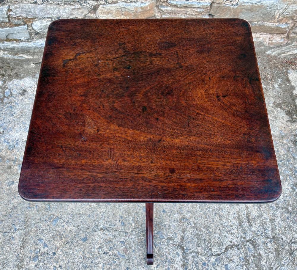 A Regency era dark mahogany tilt-top wine table featuring a rectangular surface, turned central pedestal stem, and a splayed tripod base. View III