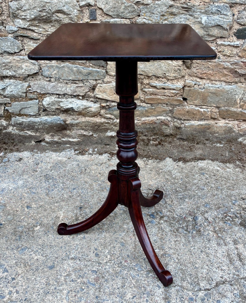 A Regency era dark mahogany tilt-top wine table featuring a rectangular surface, turned central pedestal stem, and a splayed tripod base. View IV
