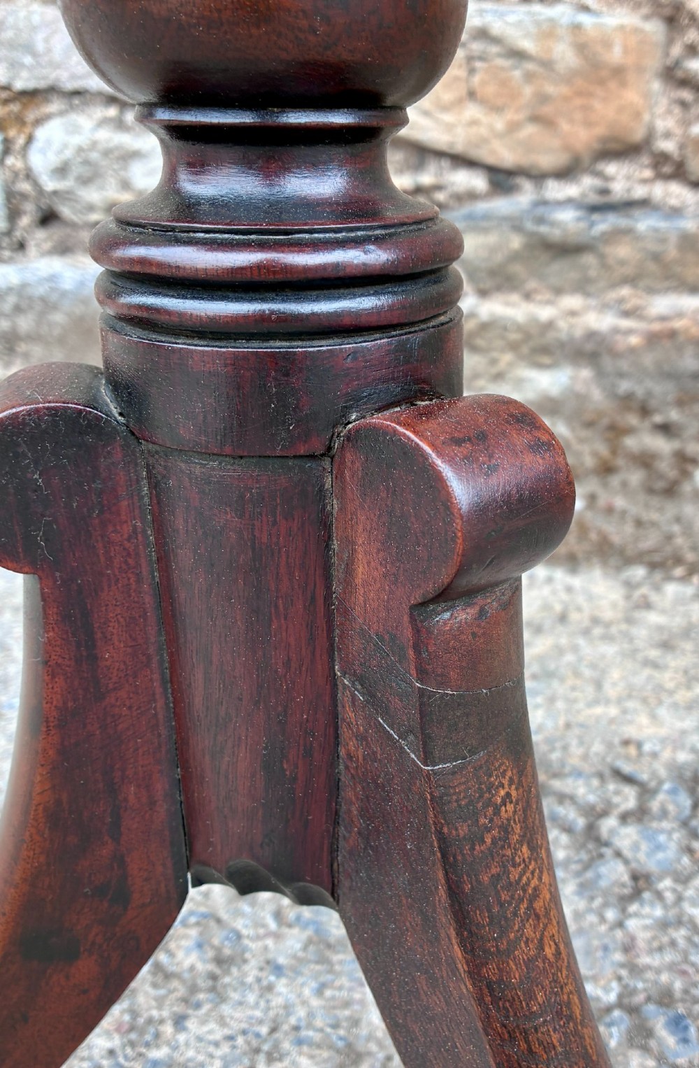 A Regency era dark mahogany tilt-top wine table featuring a rectangular surface, turned central pedestal stem, and a splayed tripod base. View VIII