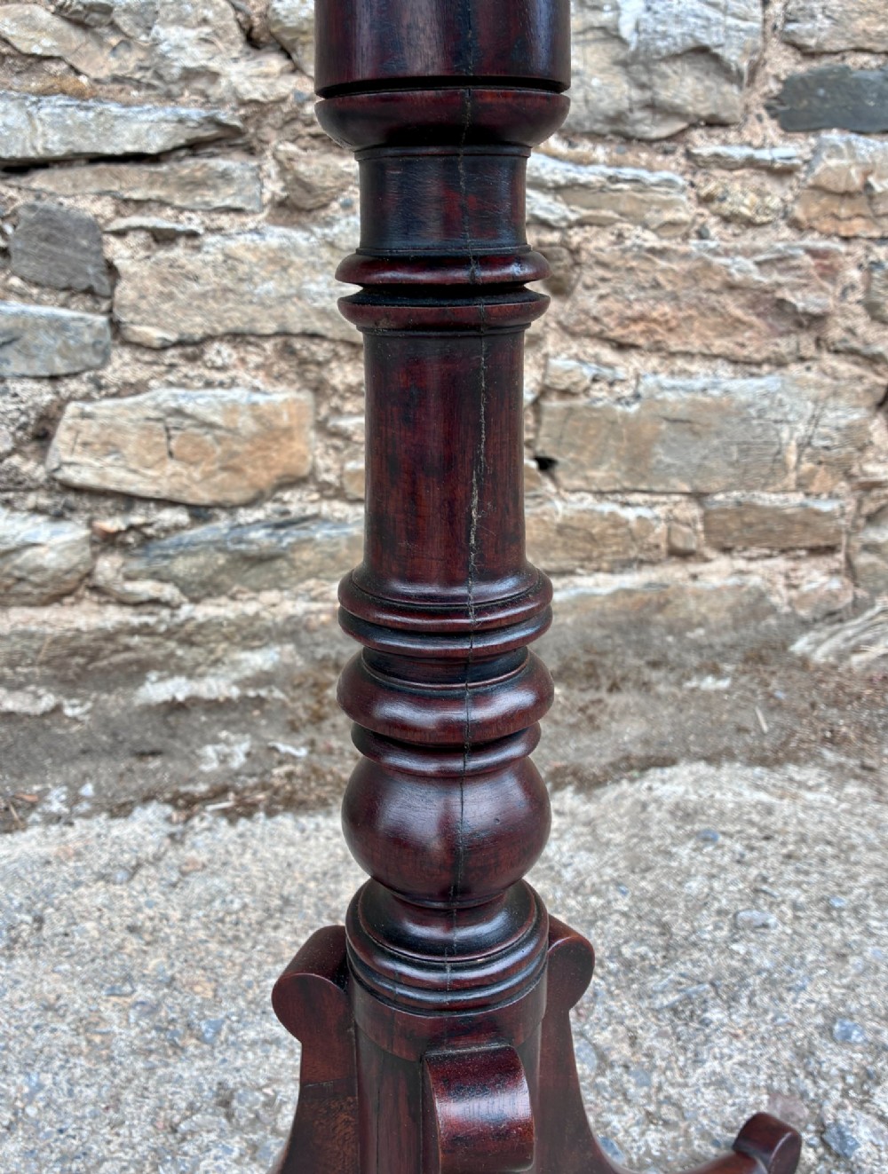 A Regency era dark mahogany tilt-top wine table featuring a rectangular surface, turned central pedestal stem, and a splayed tripod base. View IX