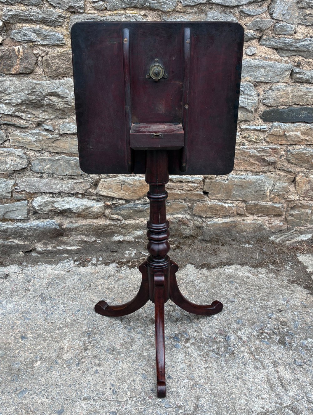 A Regency era dark mahogany tilt-top wine table featuring a rectangular surface, turned central pedestal stem, and a splayed tripod base. View XIII