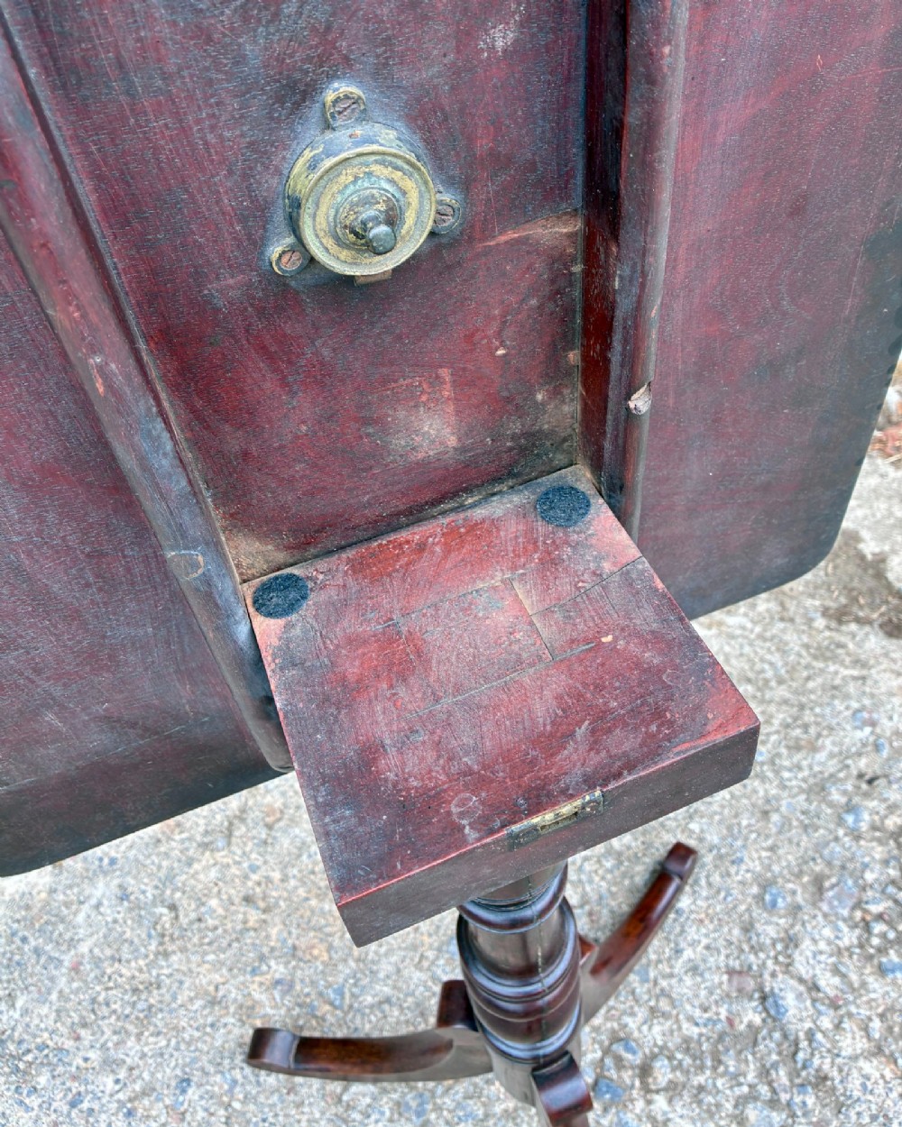 A Regency era dark mahogany tilt-top wine table featuring a rectangular surface, turned central pedestal stem, and a splayed tripod base. View XIV