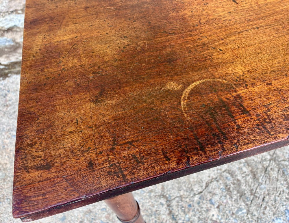 A rectangular Georgian mahogany side table featuring rounded top corners and four ring-turned tapered legs. View XI