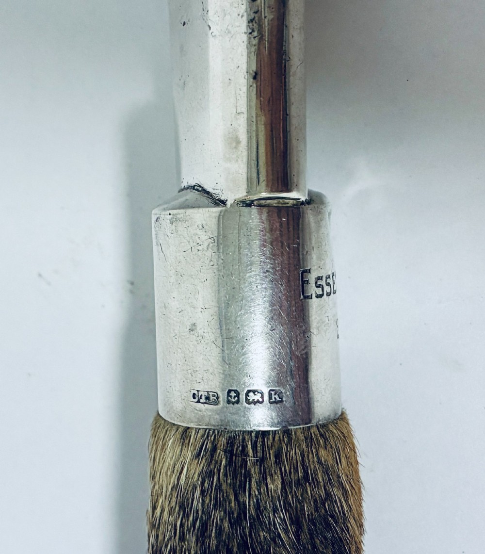 An antique page turner featuring a dark ebony blade connected via a silver collar to an otter paw handle. View IV