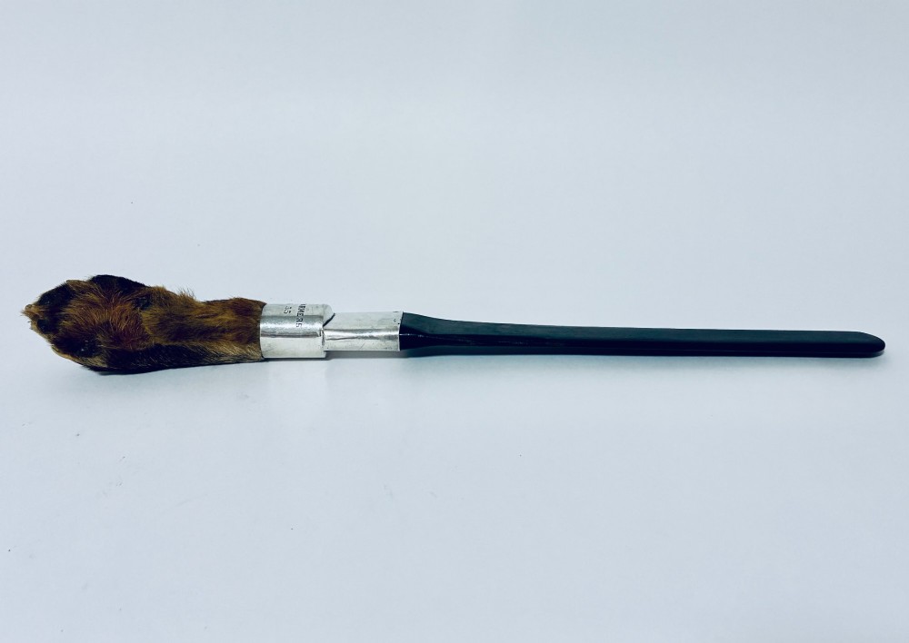 An antique page turner featuring a dark ebony blade connected via a silver collar to an otter paw handle. View VI