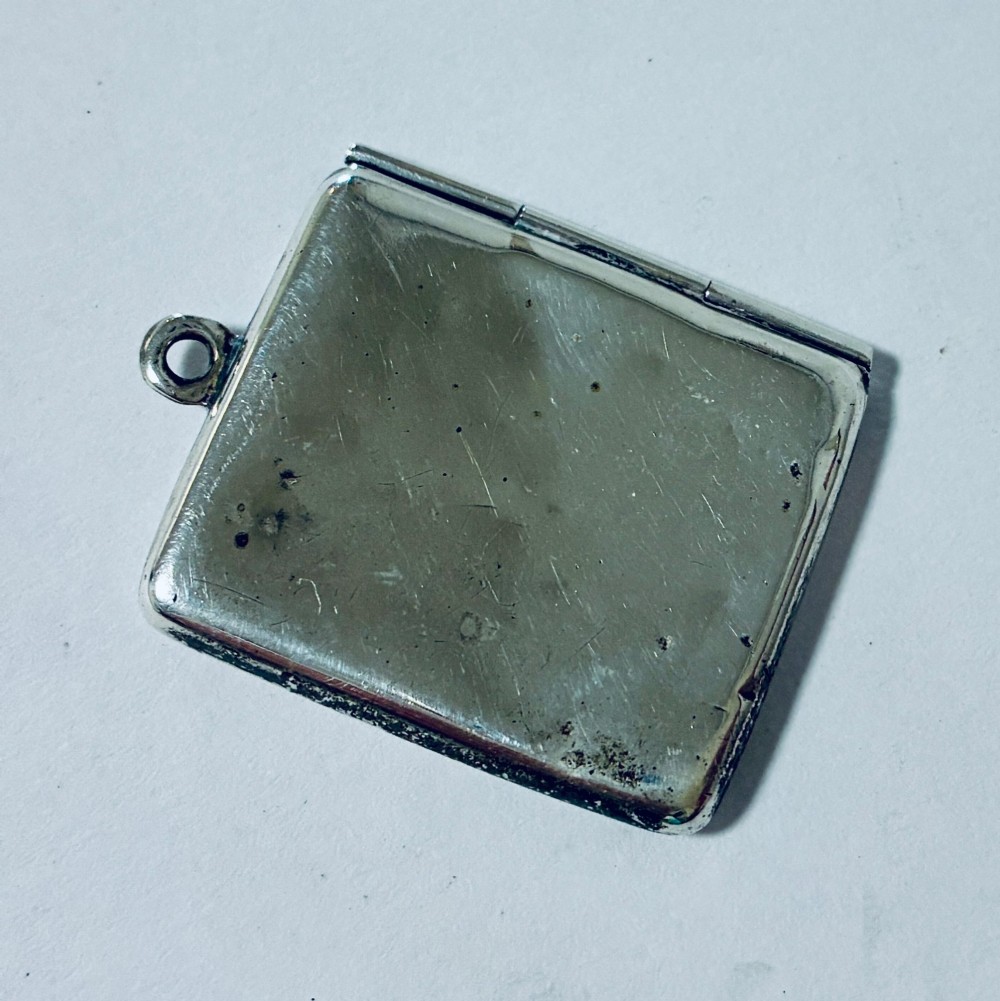 An envelope-shaped sterling silver stamp case featuring an engraved Isle of Man triskelion and clear hallmarks. View III