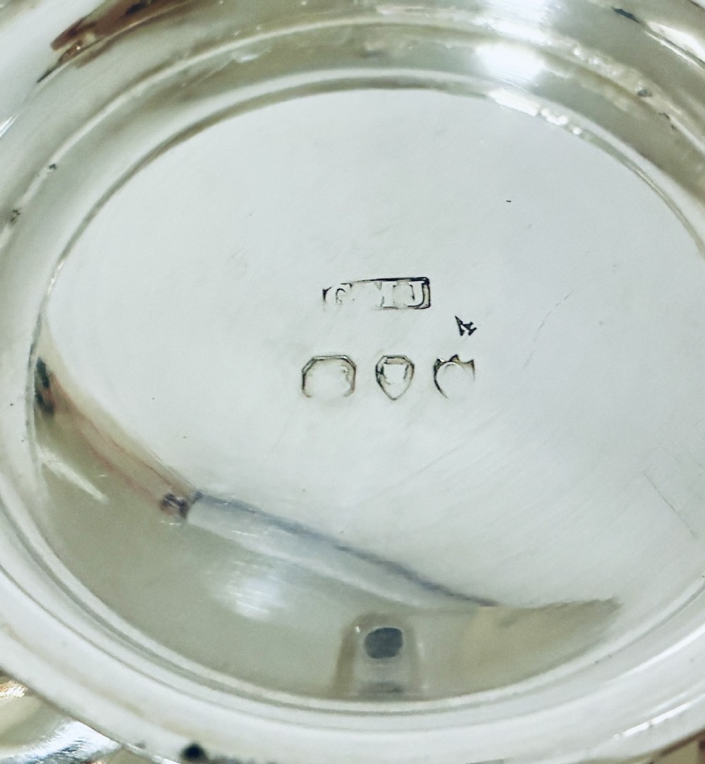 An antique silver pedestal bowl featuring spiralled fluted sides and a scalloped rim resting on a round moulded base. View VI
