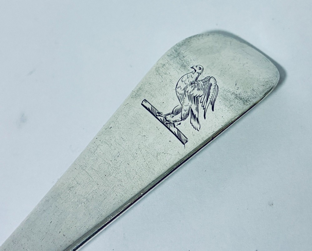An 18th-century silver serving spoon featuring an elongated oval bowl and a smooth tapered handle. View VI